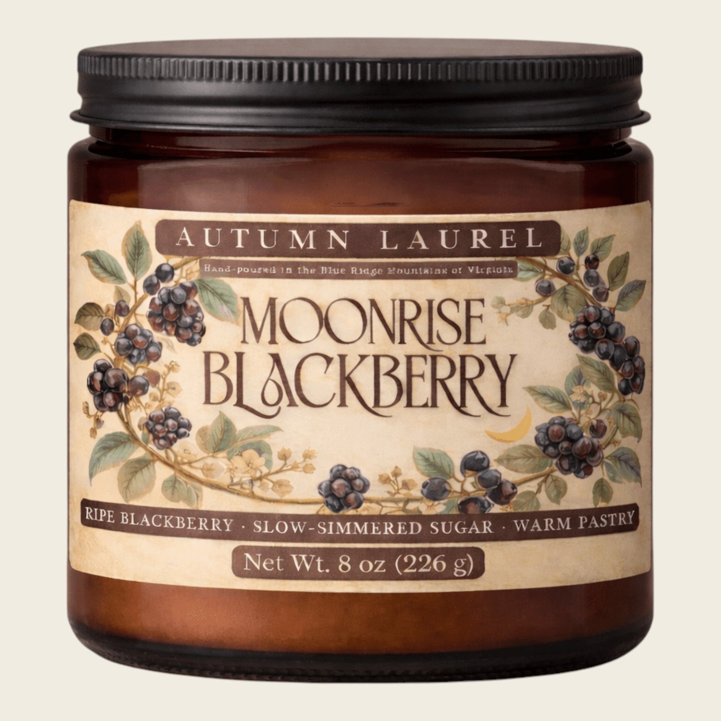 An 8 oz amber glass jar candle with a black metal lid and a vintage-style cream label reading 'Autumn Laurel Moonrise Blackberry'. The label features illustrations of blackberries and leaves on a light beige background.