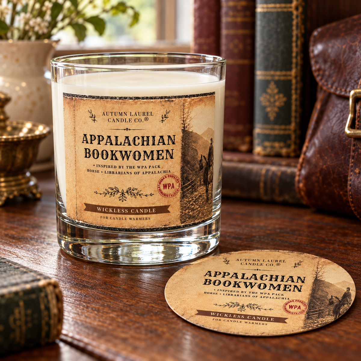 Appalachian Bookwomen wickless candle in clear Libbey rocks glass with matching paper dust cover