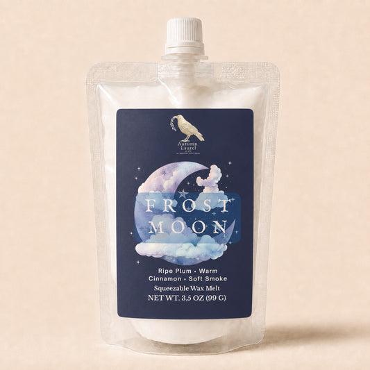 Frost Moon ripe plum, warm cinnamon and soft smoke squeezable wax melt in a 3.5 oz pouch