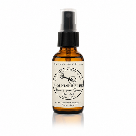 Mountain Jubilee room and linen spray in a 1 ounce amber glass bottle with cream linen label